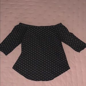 Black off the shoulder dressy shirt with designs.